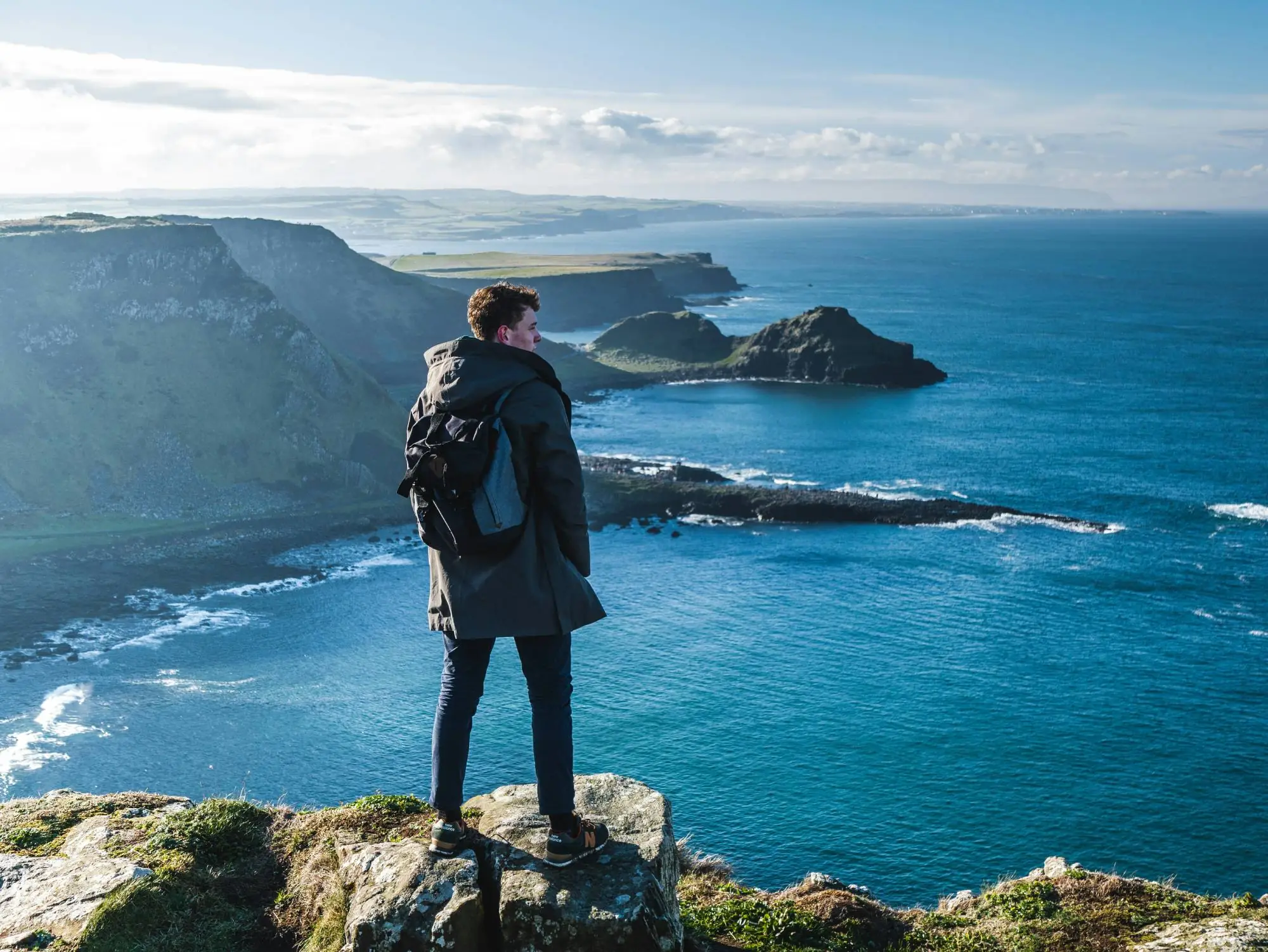 Un homme qui fait face à la vue sur la Chaussée des Géants - Felix Meynet sur Unsplash